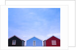 Beach huts in a row against sky by Assaf Frank